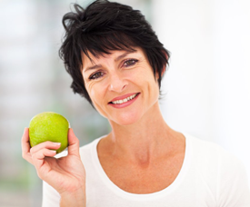 Woman with healthy smile holding an apple